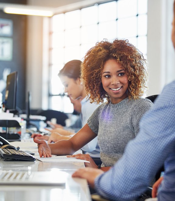 woman at office desk with laptop