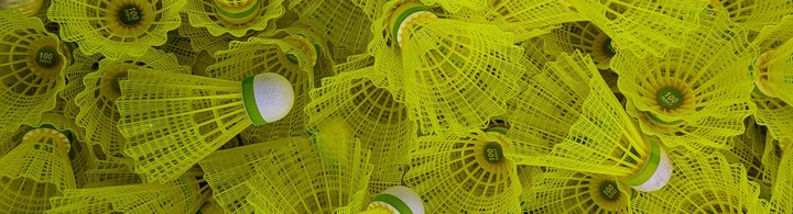 Yellow badminton shuttercocks (birdies) are an example of an item sold by the e-commerce sports market.